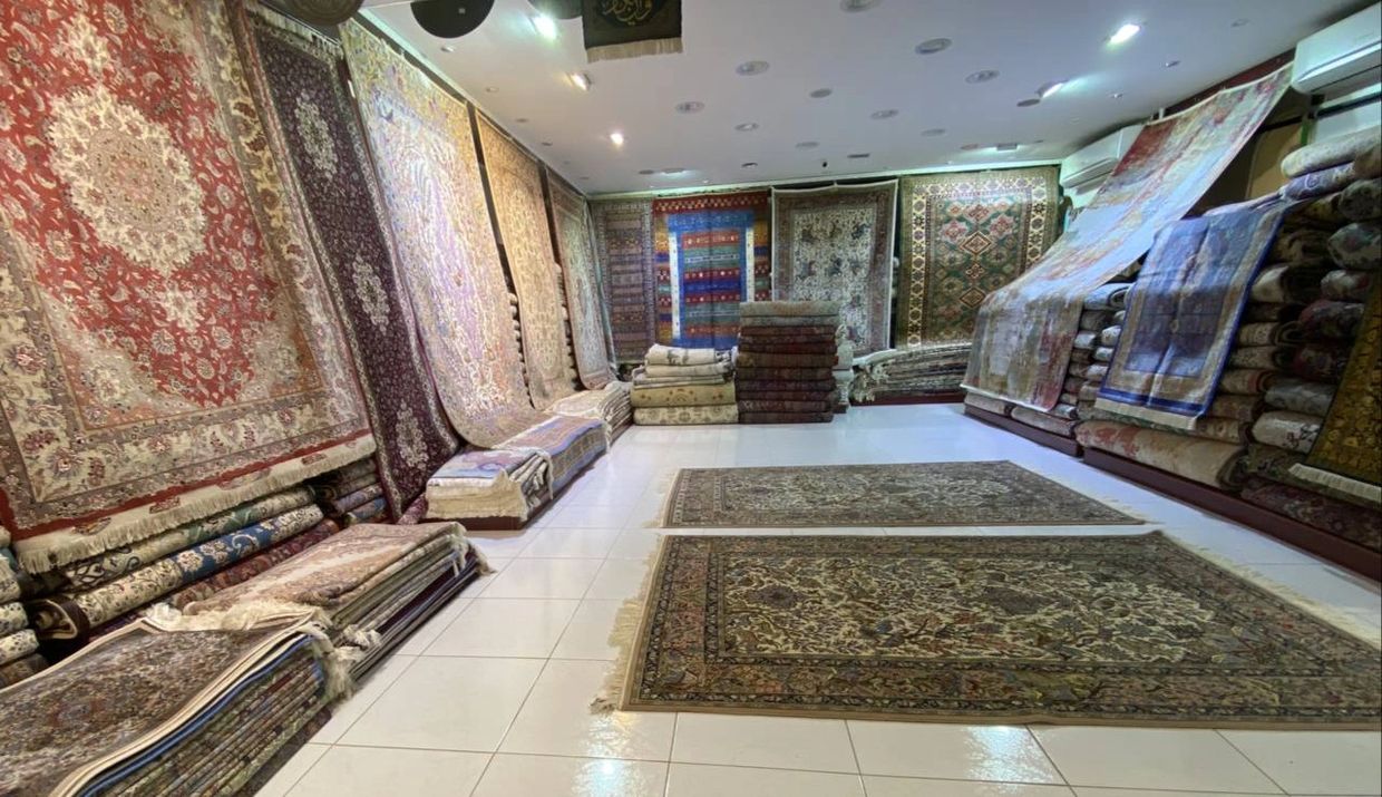 Sheba Iranian Carpets Stores Showroom with display of silk on silk rugs, Qom, Tabriz rugs.