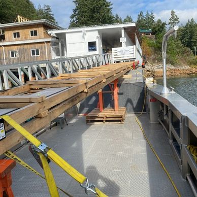 Long roofing materials strapped to the deck of our landing craft.