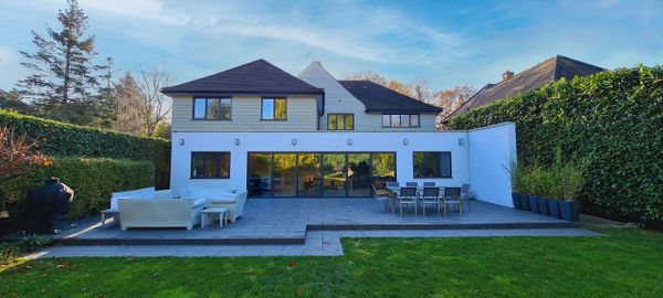 Modern backyard patio with outdoor seating and dining area.