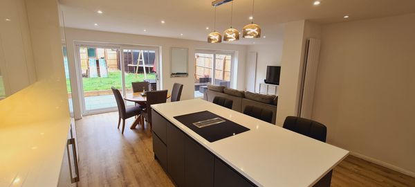 Modern open-plan kitchen and living area with garden view.