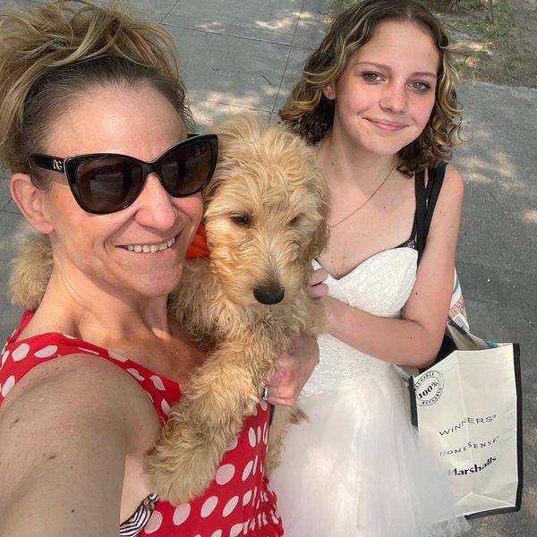 Shannon FOUNDER of ColioCo Doodles delivering a Calgary Goldendoodle puppy with my daughter