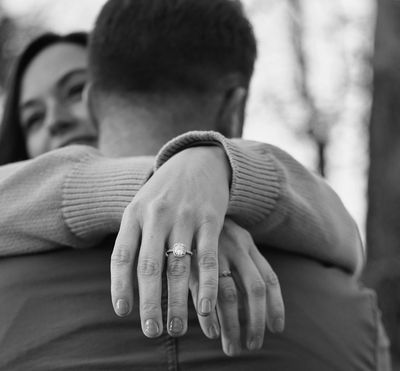 Close-up of an engagement ring on a woman’s hand after a surprise proposal in the Smoky Mountains. 
