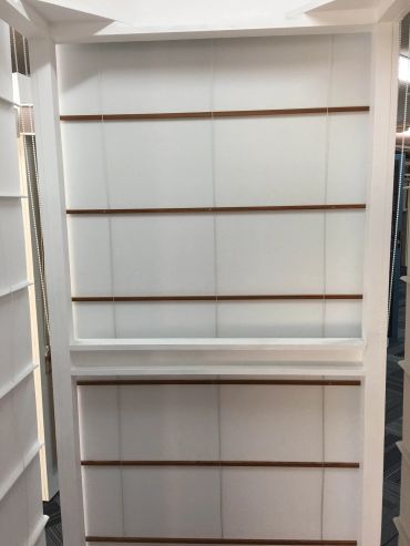 White panel display with horizontal wooden slats in an indoor setting.