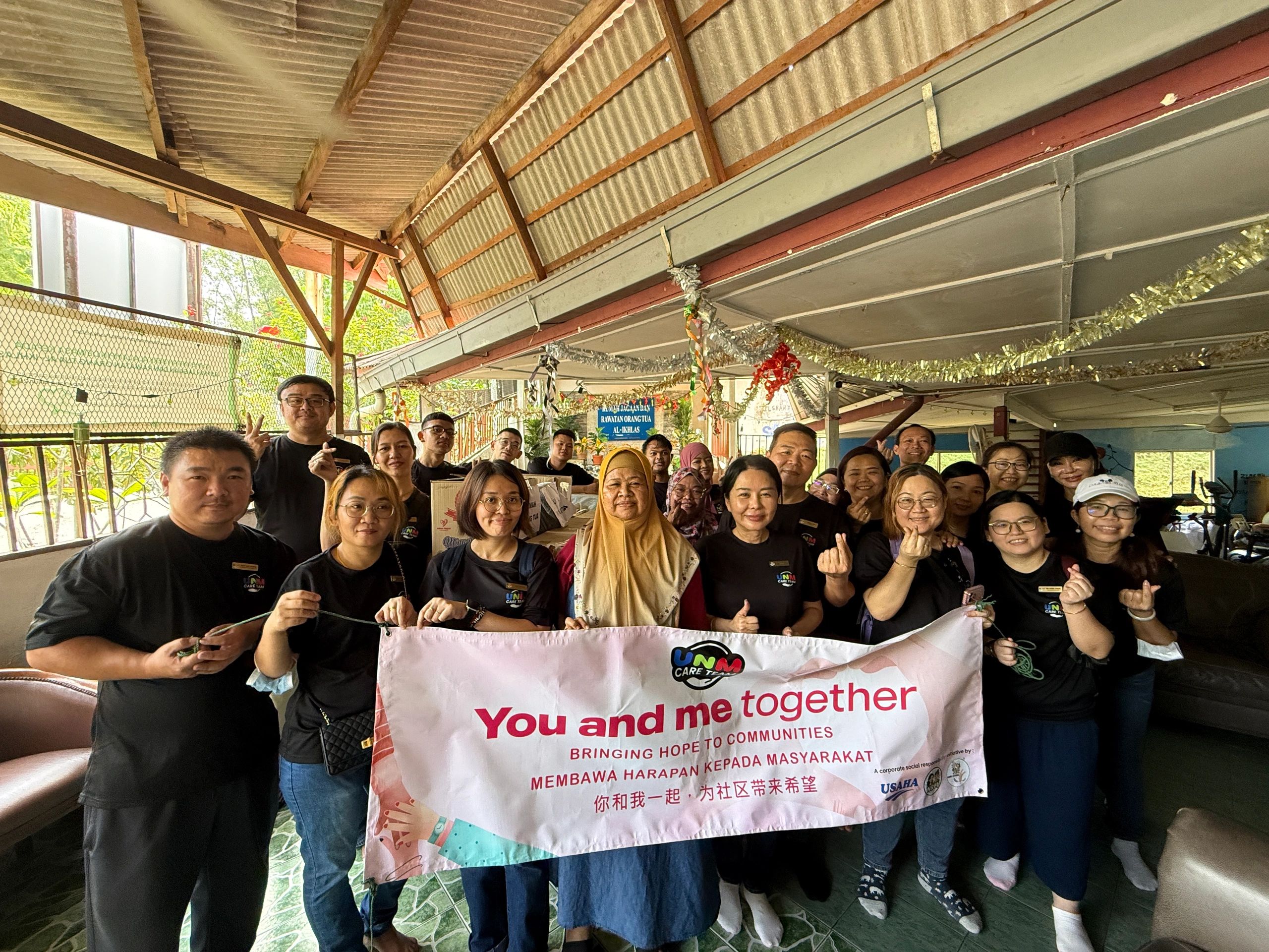 Group of people holding a banner promoting hope and community support.