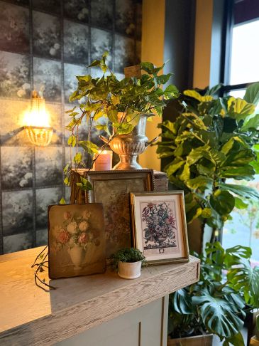 Interior styling vignette with plants, vintage artwork and furnishings at Lavender Living