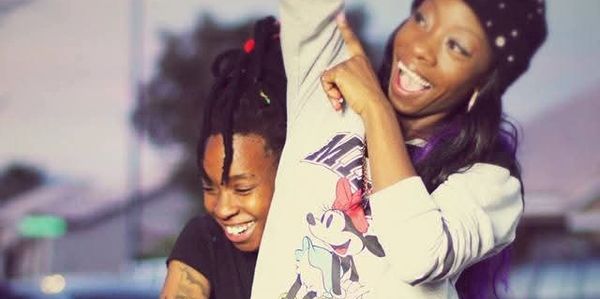 Two friends laughing and enjoying outdoors.