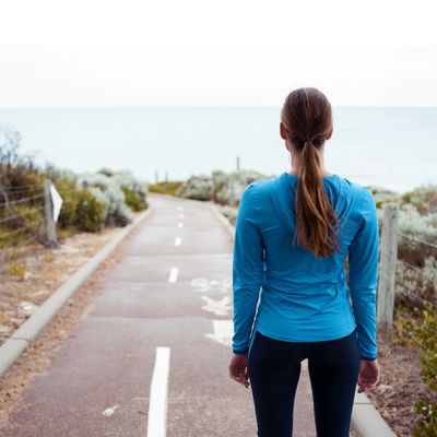 stationary woman looking at road ahead