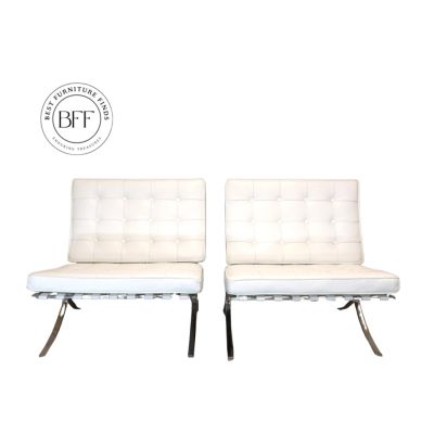 Pair of modern white leather chairs with tufted backs and metal legs.