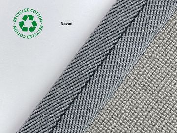 Close-up of fabric with recycled cotton label and textured edge.
