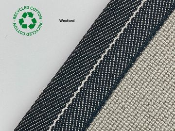 Close-up of recycled cotton fabric labeled 'Wexford' with textured beige material.