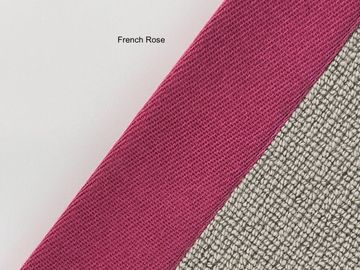 Close-up of fabrics labeled French Rose with textured surfaces.