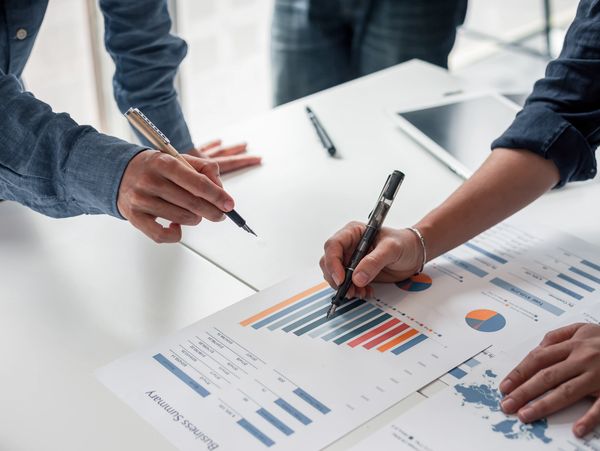 Group of business people meeting together Pointing to the graph assess business profits