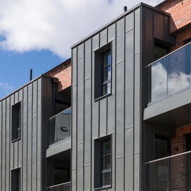 An image of an apartment building in York with zinc cladding, glass balustrading & aluminium windows