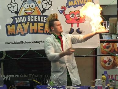 Science entertainer from Mad Science Mayhem performing fire stunt in public