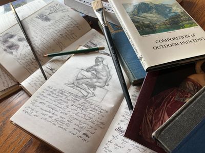 Photograph of art study books and drawings . 