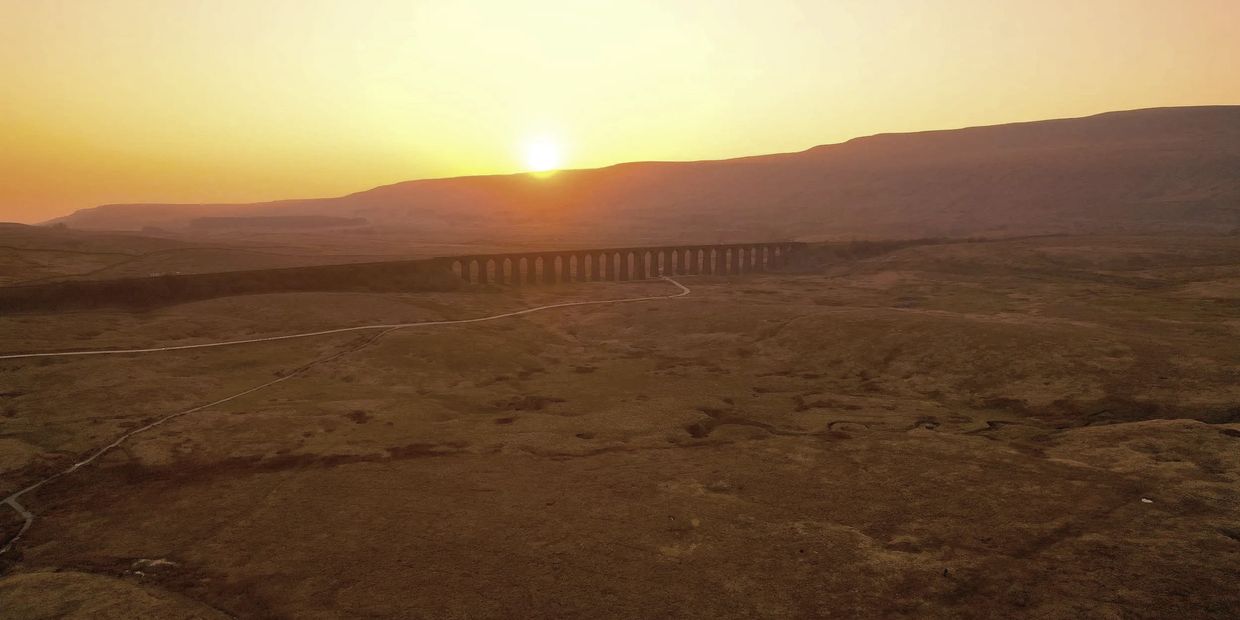 Aerial photography and Drone Photography photo of Ribblehead Viaduct with setting sun.