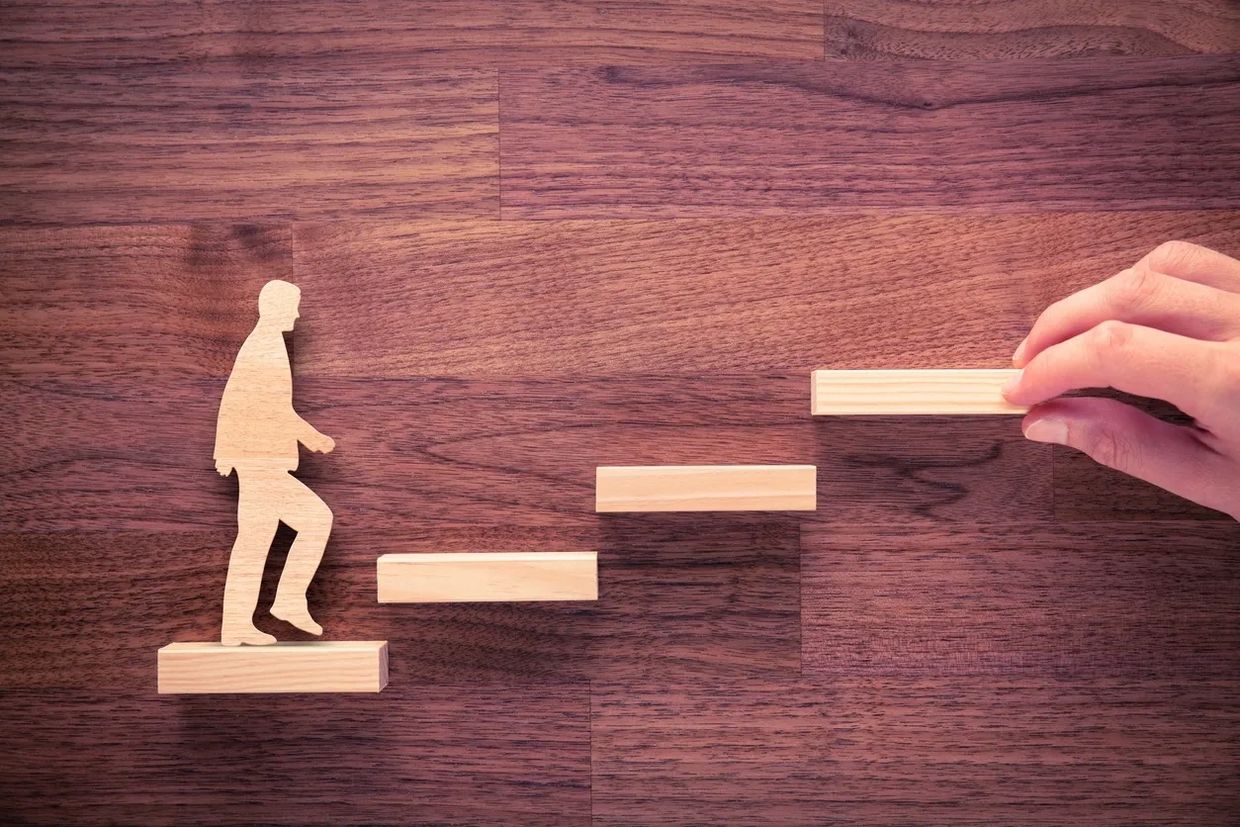 A Wooden Figure of a Man With Wooden Stairs