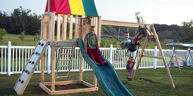 Small Single tower wood playset with slide and swings and rockwall