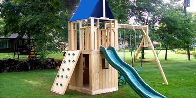 Small single tower with rockwall, clubhouse bottom, slide and swings