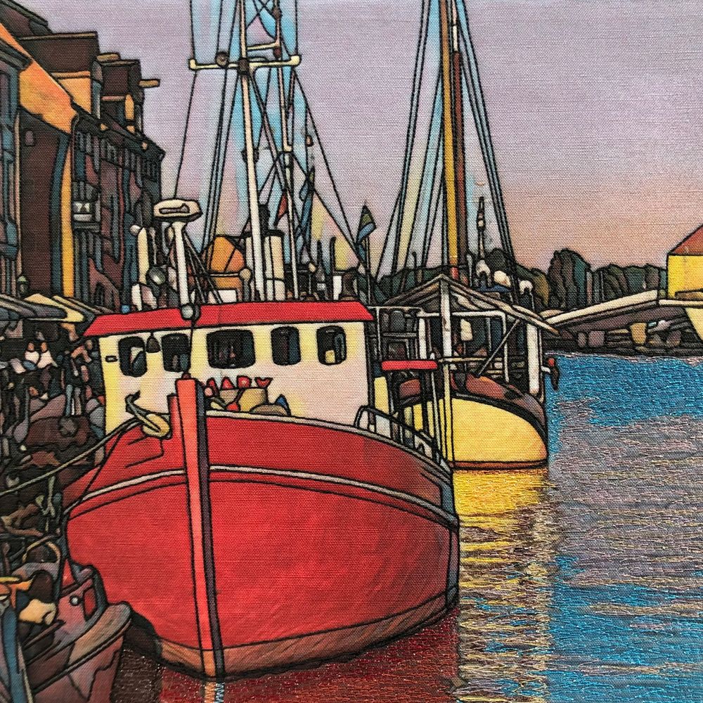 Colorful boats docked at a vibrant harbor during sunset.