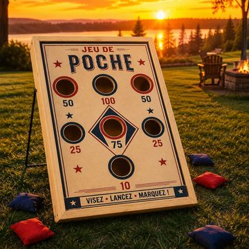Outdoor cornhole game board set up during sunset on a lawn.