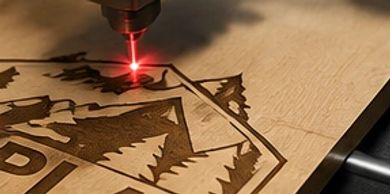 Laser engraving a wooden surface with a nature-themed design.
