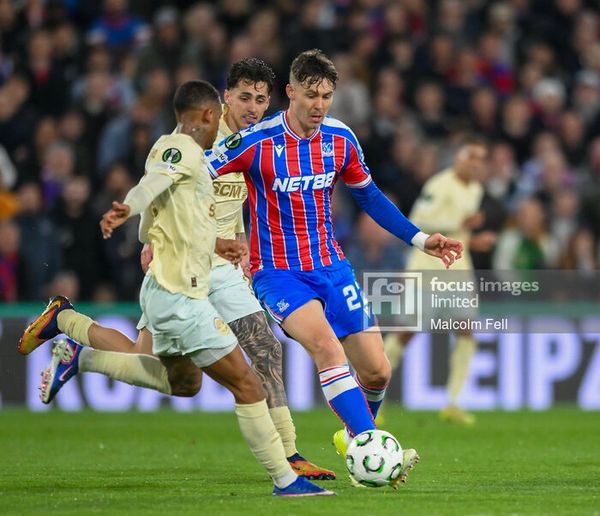 Soccer players competing intensely for the ball during a match.