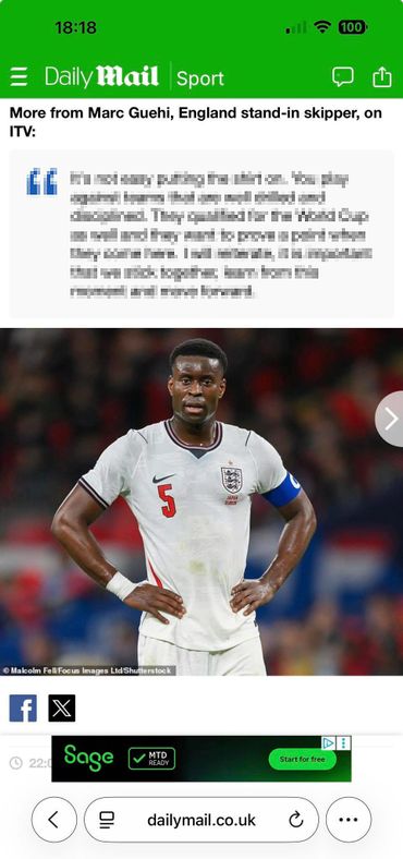 Marc Guehi, England footballer, in a white jersey with captain's armband during a match.