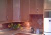 New maple cabinets and colour coordinated backsplash for a smaller kitchen.