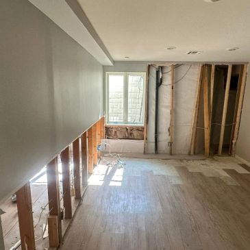 Room under renovation with exposed lower walls and floor.
