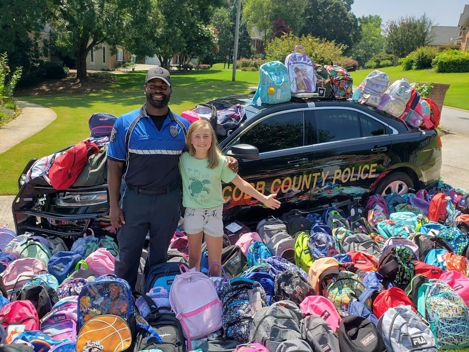 Cobb County Police Officer Akram & Jaida Burke with donated supplies for Backing the Need 2021.