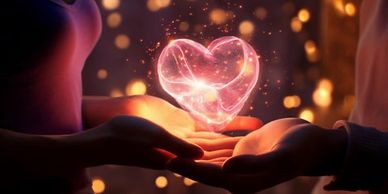 Two hands holding a glowing, heart-shaped light symbolizing love.