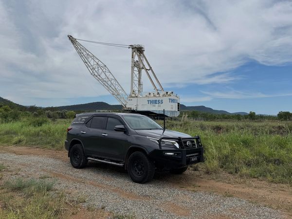 dark grey car parked in front of dragline
