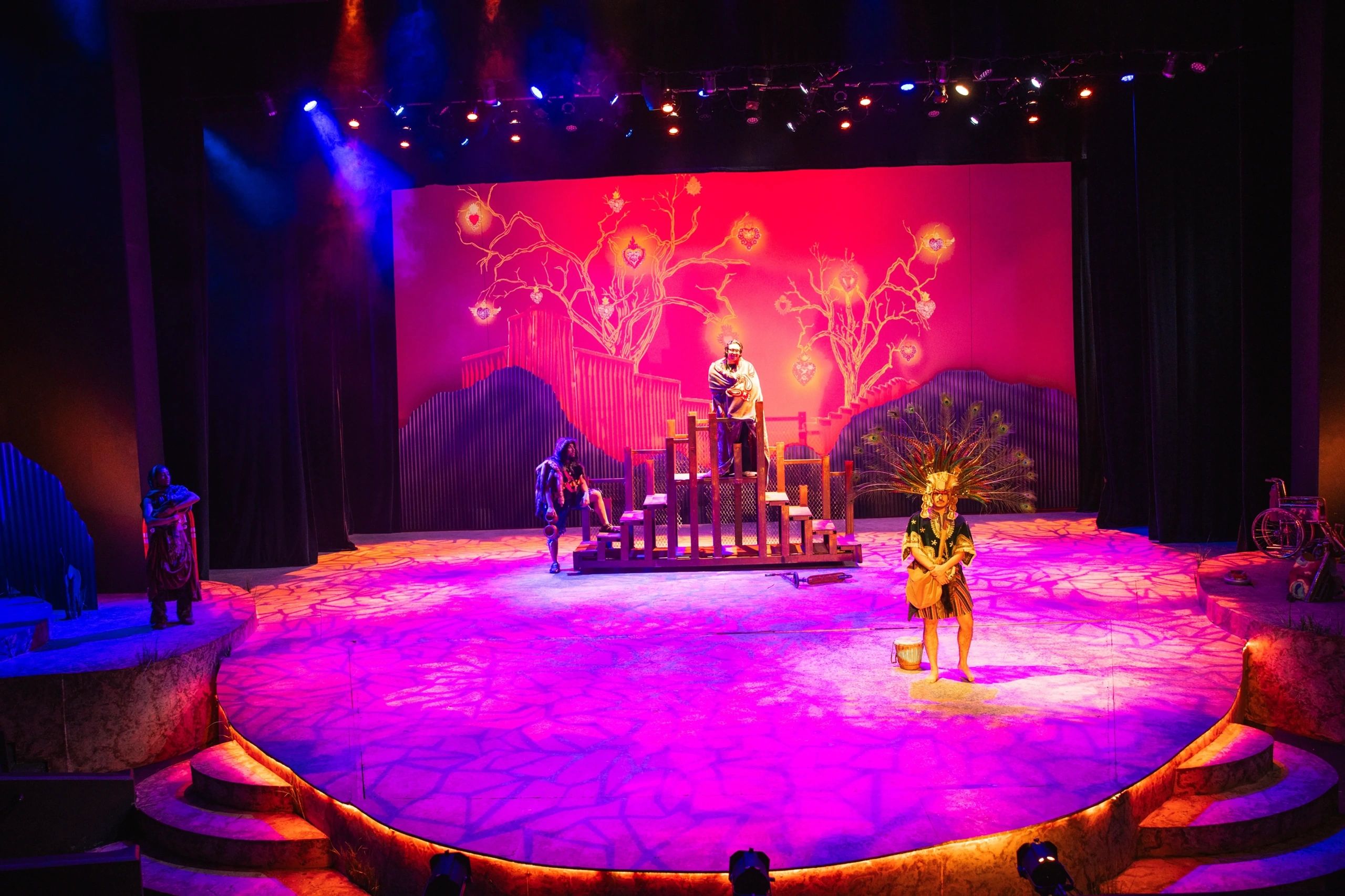 Colorful theatrical stage with actors and vibrant lighting.