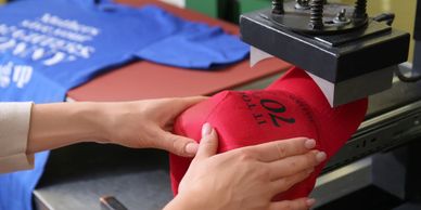 Hands embroidering cap and silkscreen t-shirt.