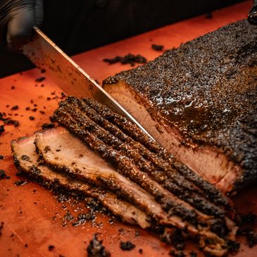 Freshly smoked brisket being sliced