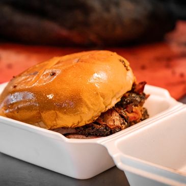 Smoked brisket sandwich in a to-go container