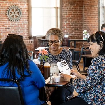 Group of people sitting in a restaurant talking and laughing