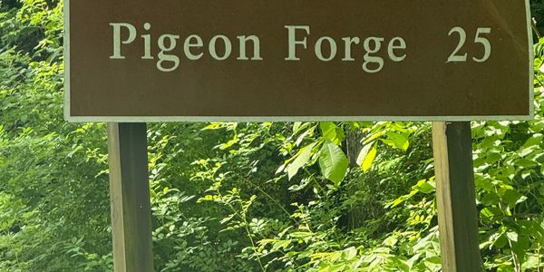 Road sign indicating Pigeon Forge is 25 miles away.