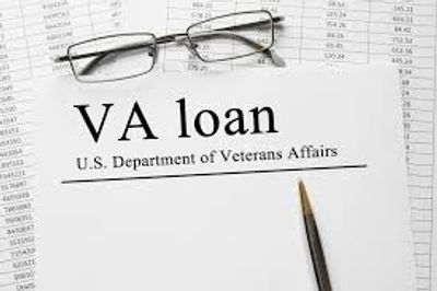 VA loan document with glasses and pen on financial papers.