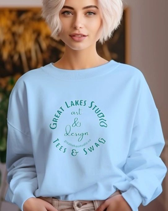Woman wearing a light blue sweatshirt with Great Lakes Studio logo.
