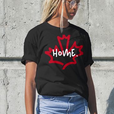 Woman wearing a black T-shirt with a red maple leaf and the word 'Home'.