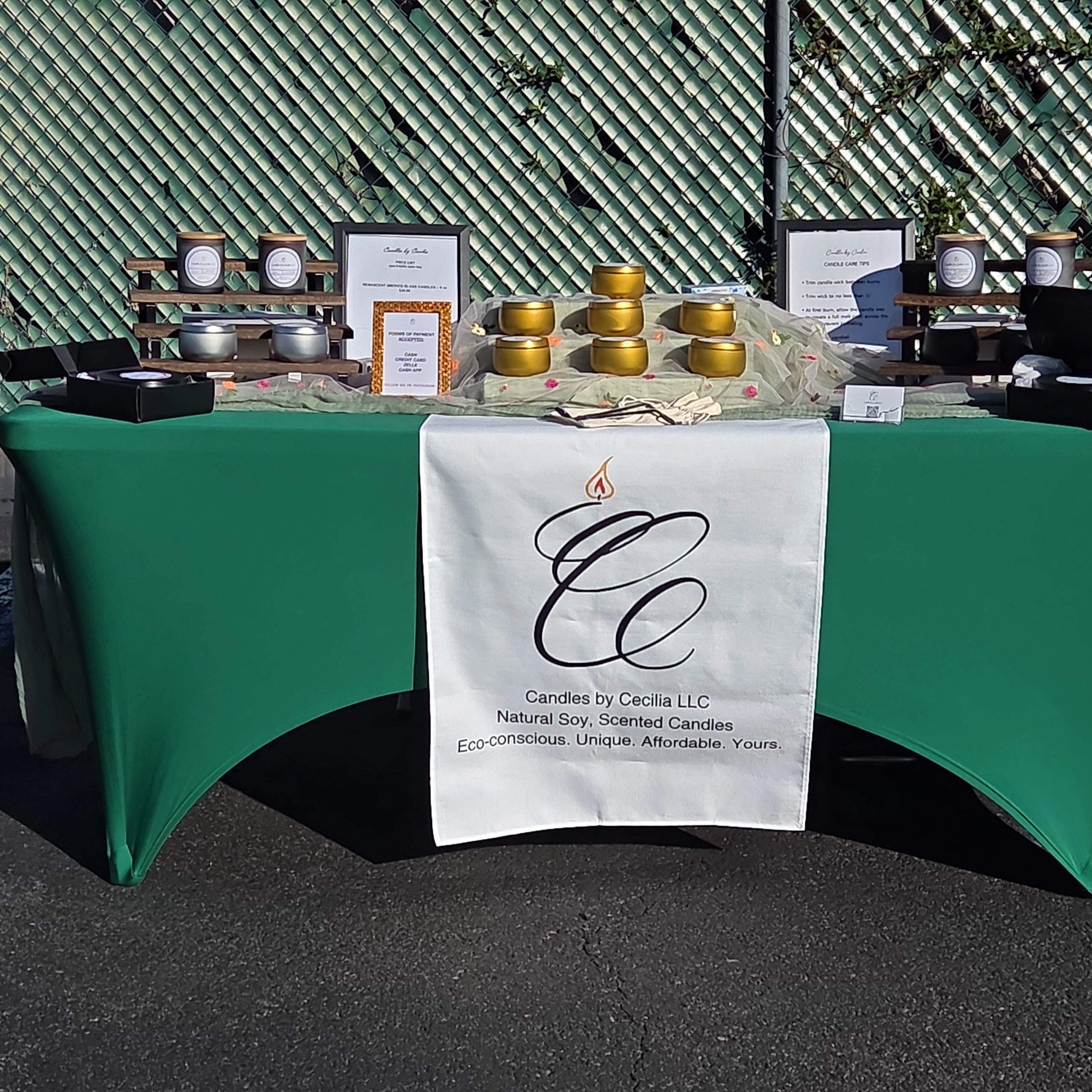 Outdoor market display of eco-conscious, natural soy scented candles by Candles by Cecilia LLC.