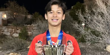Enzo holding the winning trophy during a tournament in St George, Utah
