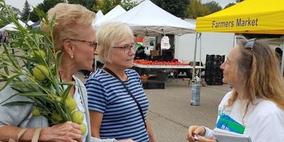 Mary speaking with two female constituents at the Farmers Market.