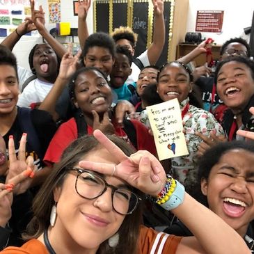 A title one teacher with her students cheering her on