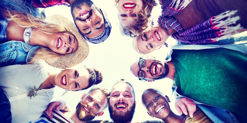 Group of friends smiling in a circle.