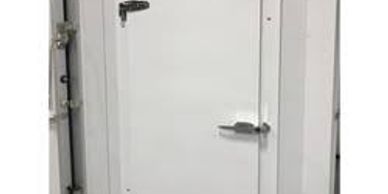 Small white industrial door with hinges and handle.