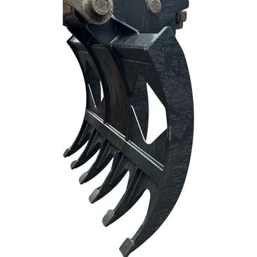 Close-up of a heavy-duty excavator grapple attachment with multiple curved tines.