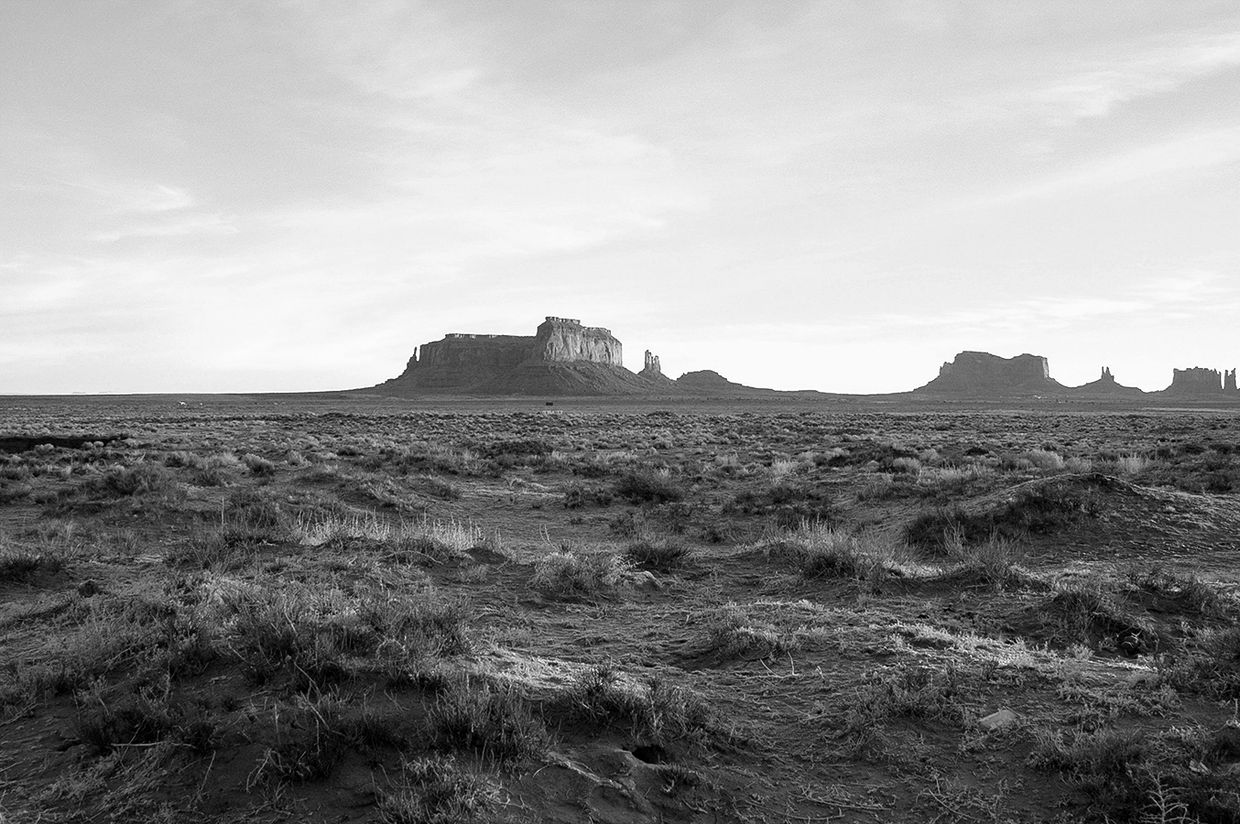 Desert landscape with rock formations in black and white.